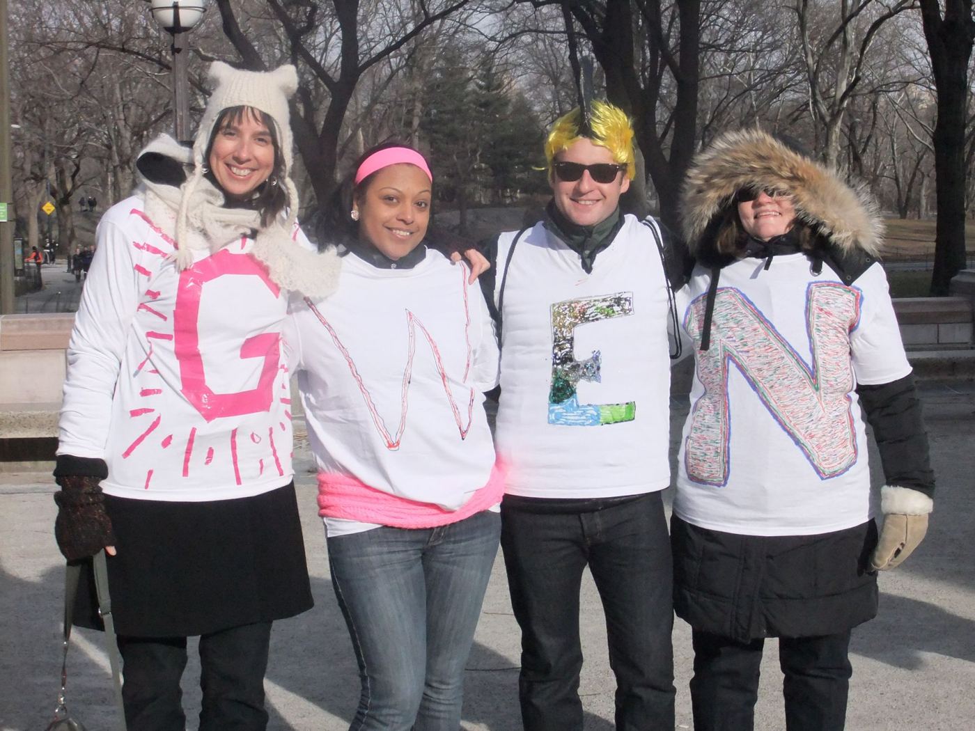 Friends in Central Park wearing shirts that spell GWEN