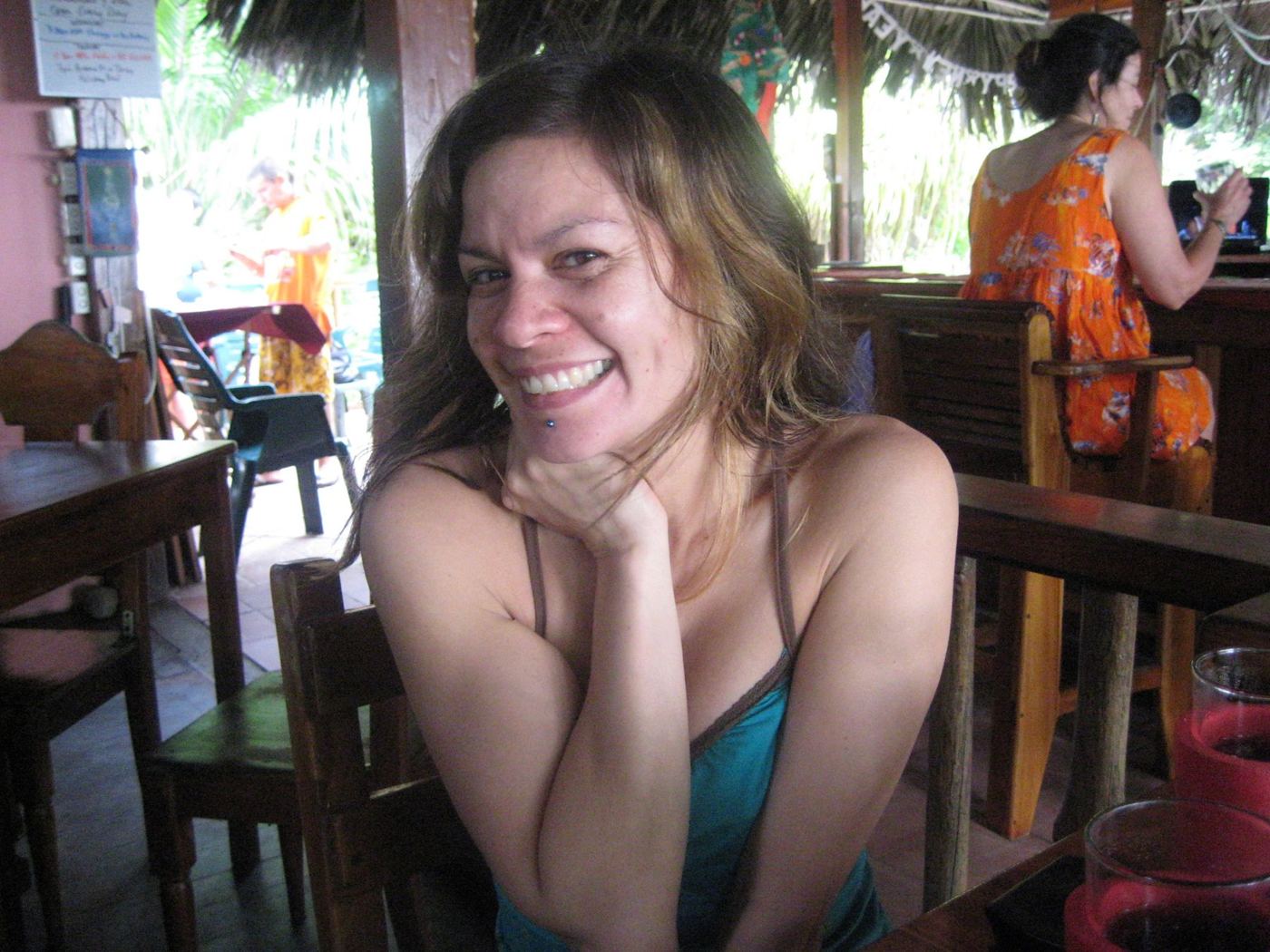 Gwen laughing at a cafe table