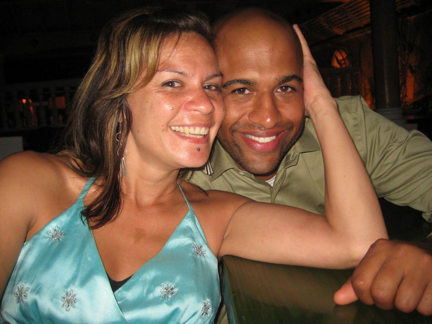 Gwen and Yasir smiling together at dinner
